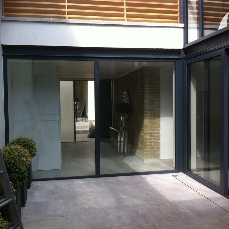 Floor-to-ceiling sliding doors opening to courtyard in Waltham Cross