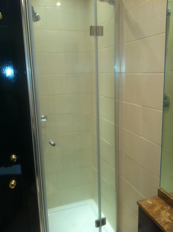 Frameless glass shower enclosure with chrome fittings in Waltham Cross