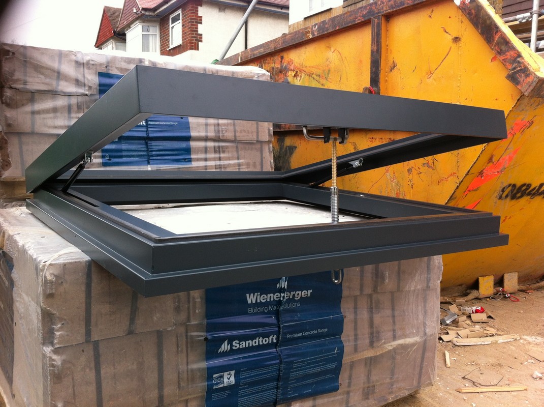 Opening flat roof skylight in anthracite grey installed in Waltham Cross