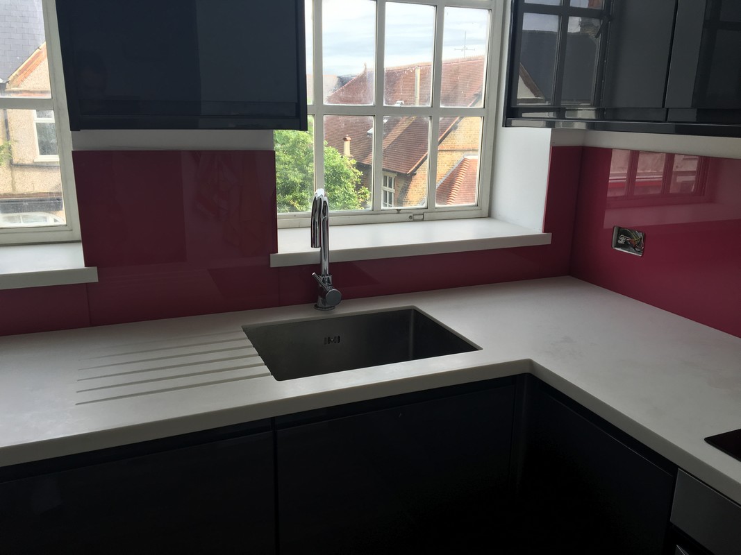 Deep plum coloured glass splashback in modern Waltham Cross kitchen
